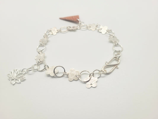 Sterling silver bracelet with a sterling and birch bark pendant.