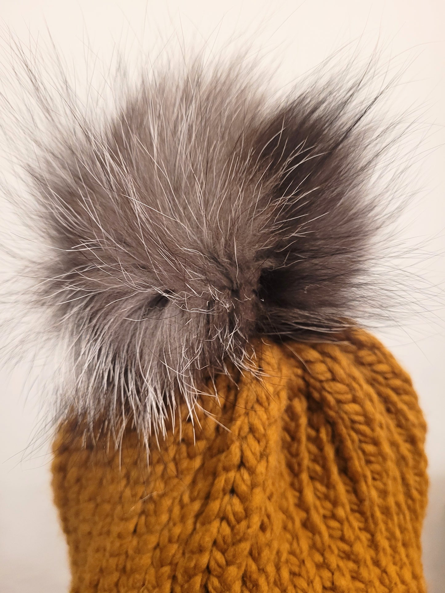 Butterscotch wool and acrylic hat with a silver fox fur pompom