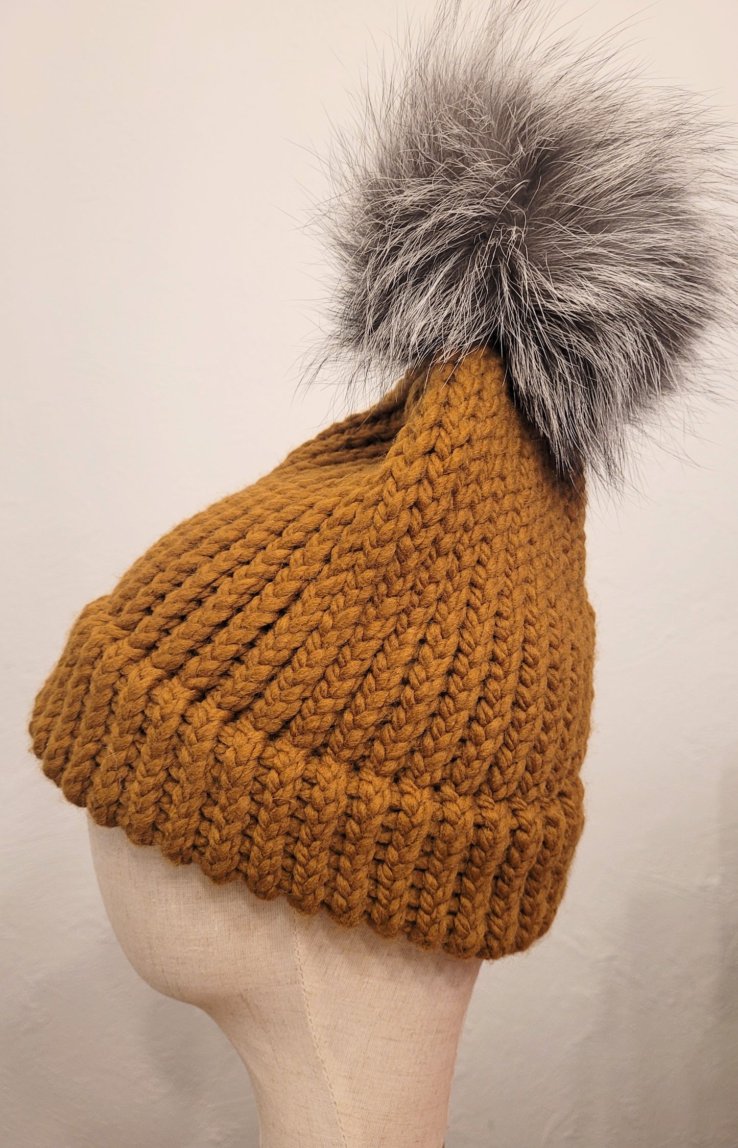 Butterscotch wool and acrylic hat with a silver fox fur pompom